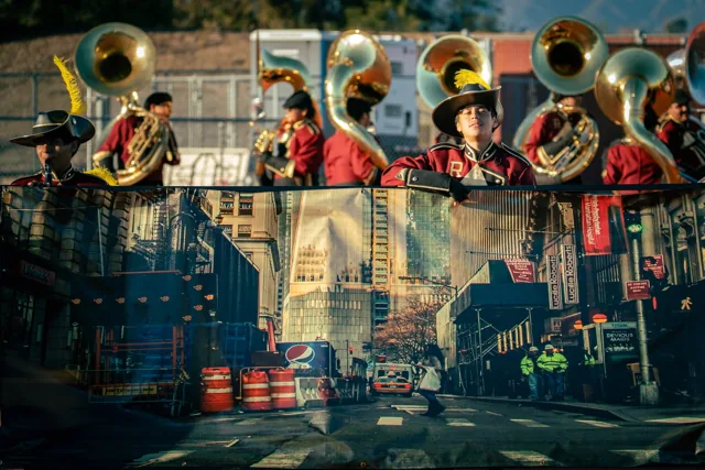 Crimson-uniformed brass musicians behind a cityscape stage prop at the Wilson Field Tournament on October 24, 2026