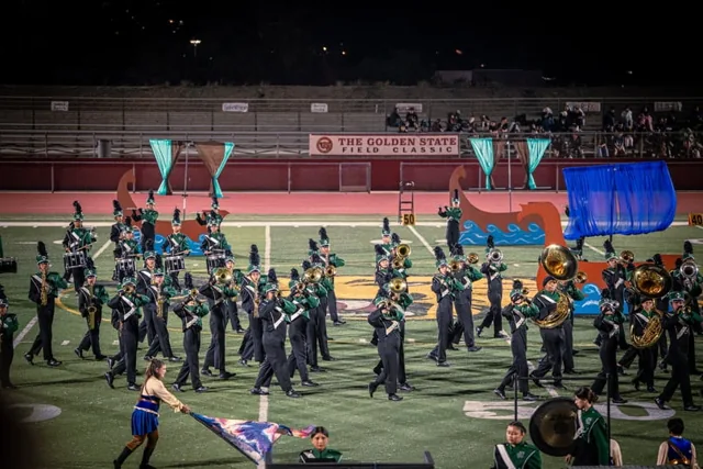 A marching ensemble and color guard performing a field formation at the Wilson Field Tournament on October 24, 2026
