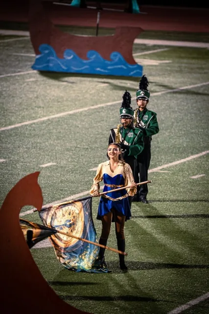 Color guard performers and musicians arranged in a diagonal line at the Wilson Field Tournament on October 24, 2026