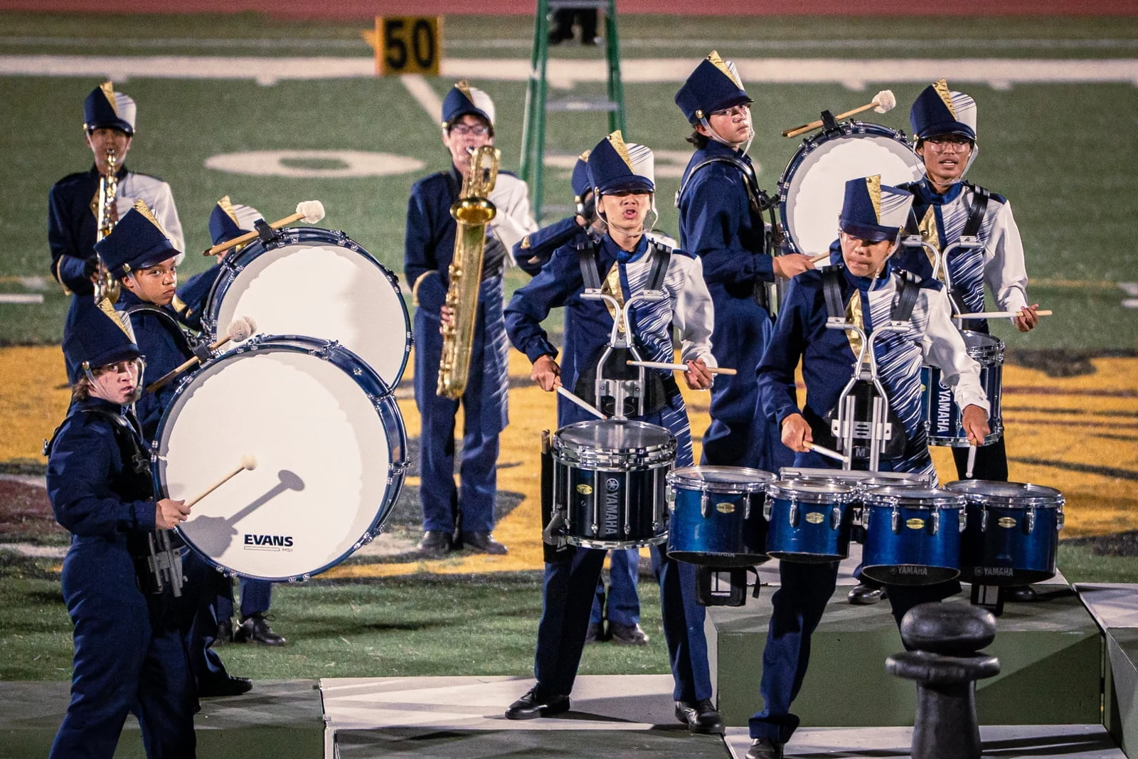 Bass drummers and tenor drummers performing together on the field at the Wilson Field Tournament on October 24, 2026